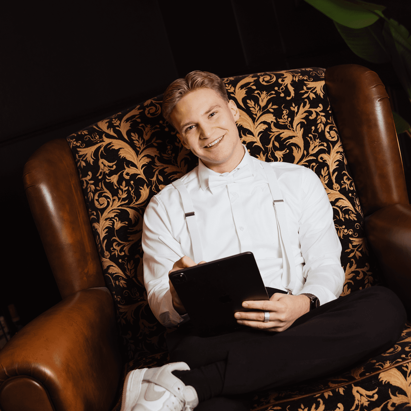 A red hot air balloon glows at sunset over mountains.