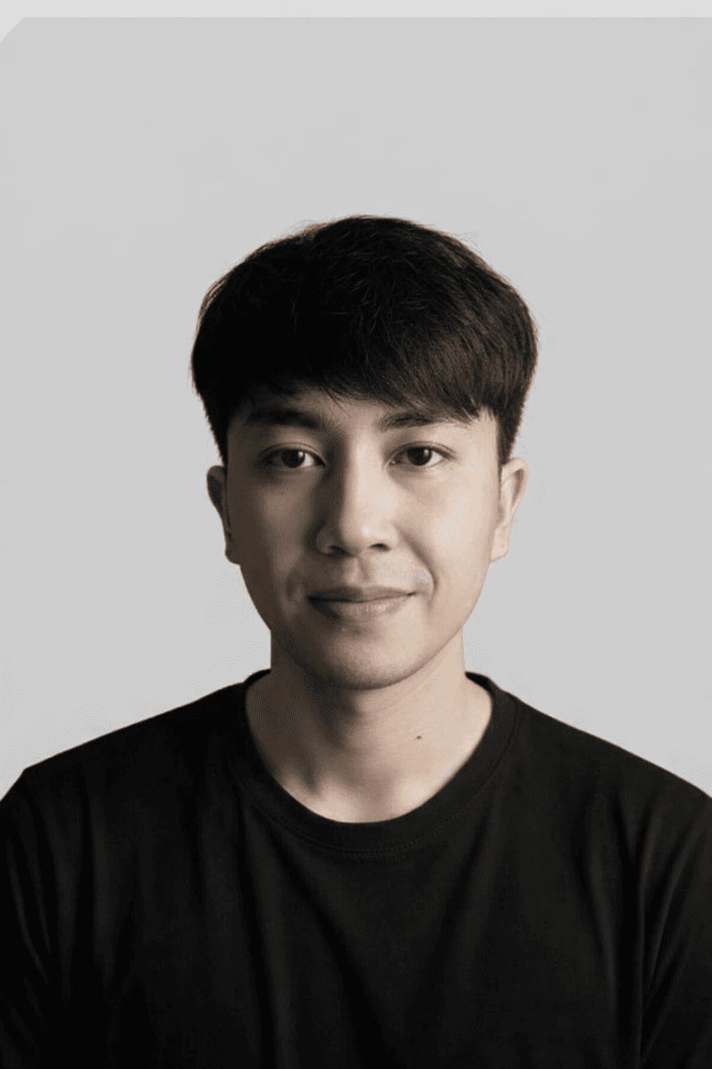 A man with glasses and a brown shirt, crossing his arms.