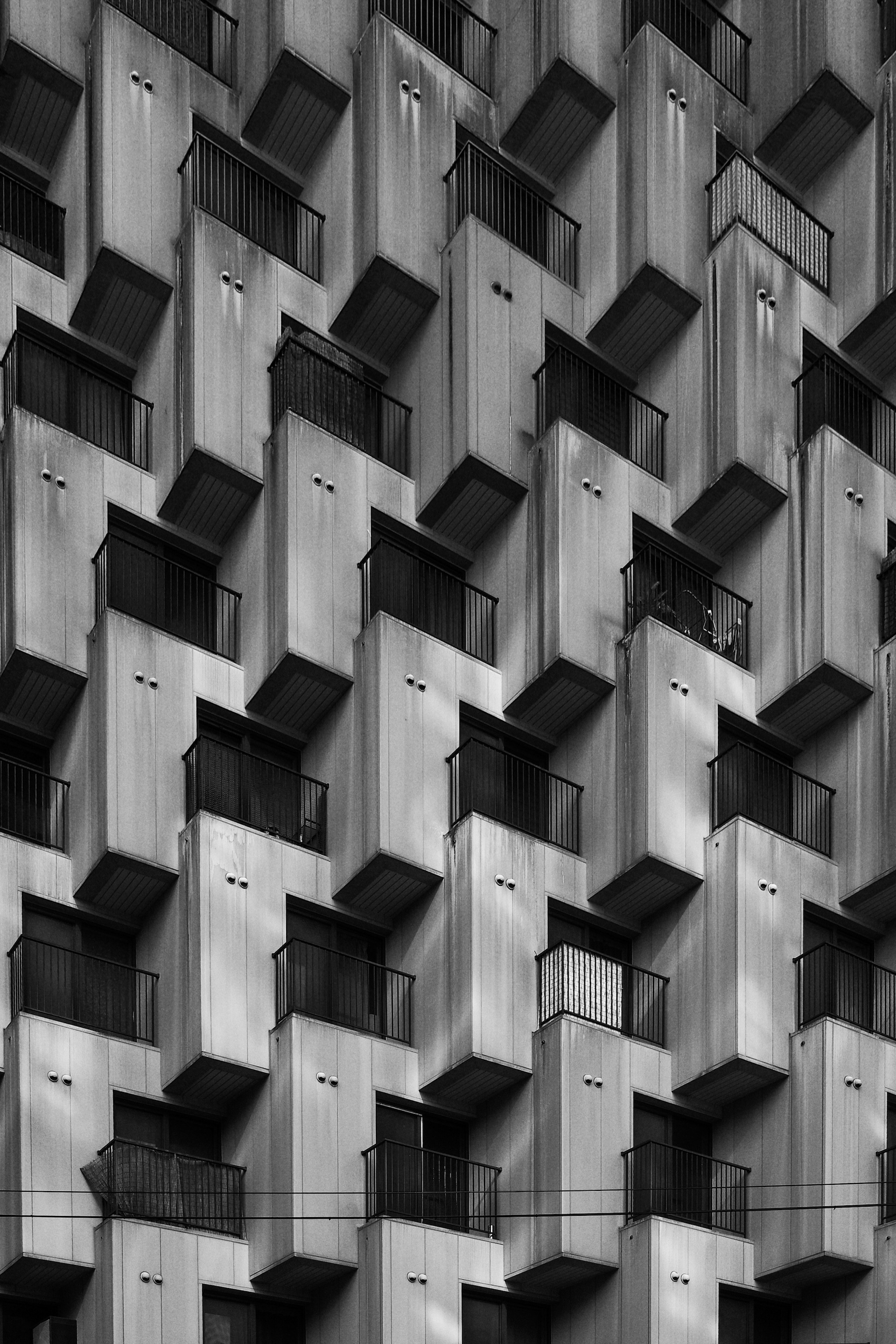Modern concrete building with repeating balcony patterns