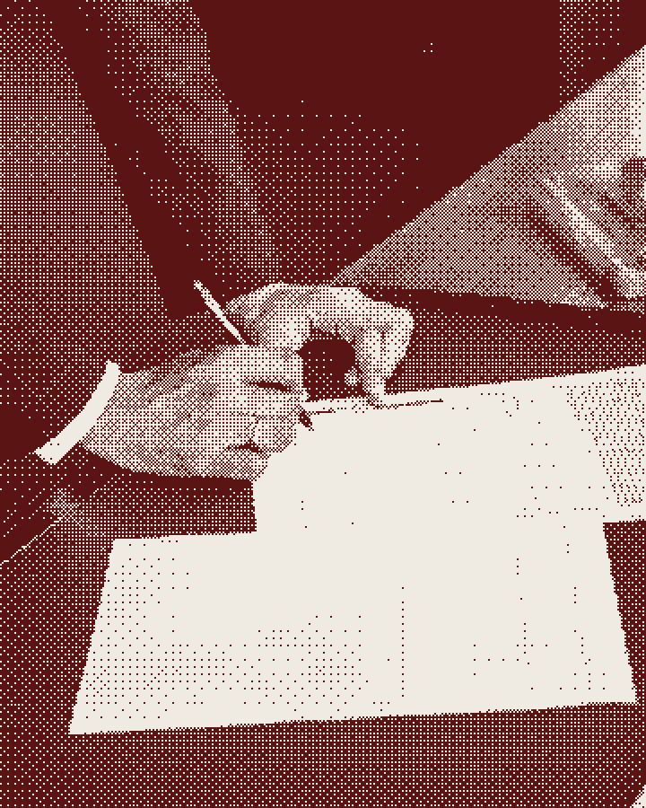 A hand signing a form
