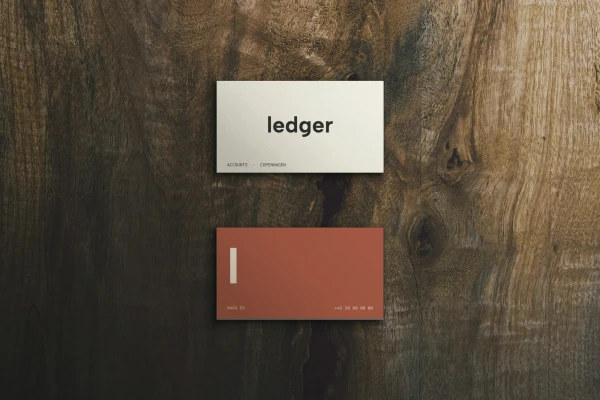 Two business cards on walnut