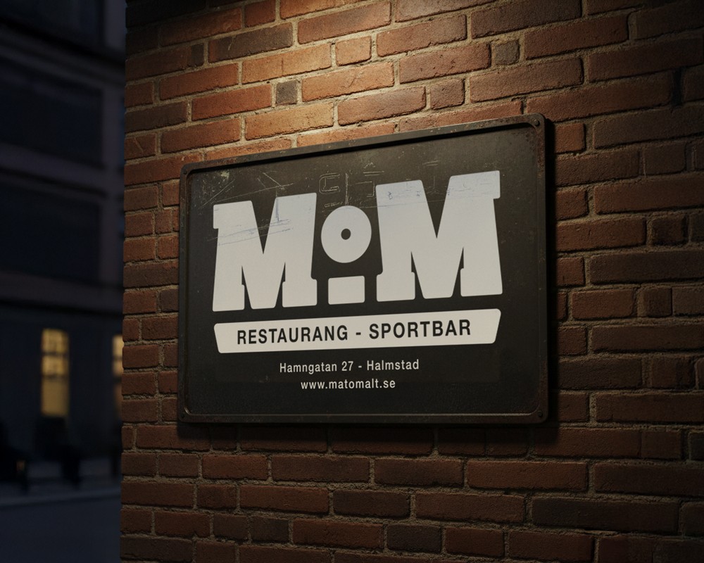  Illuminated block-letter MOM sign mounted on a dark wooden wall inside the Mat & Malt restaurant space.