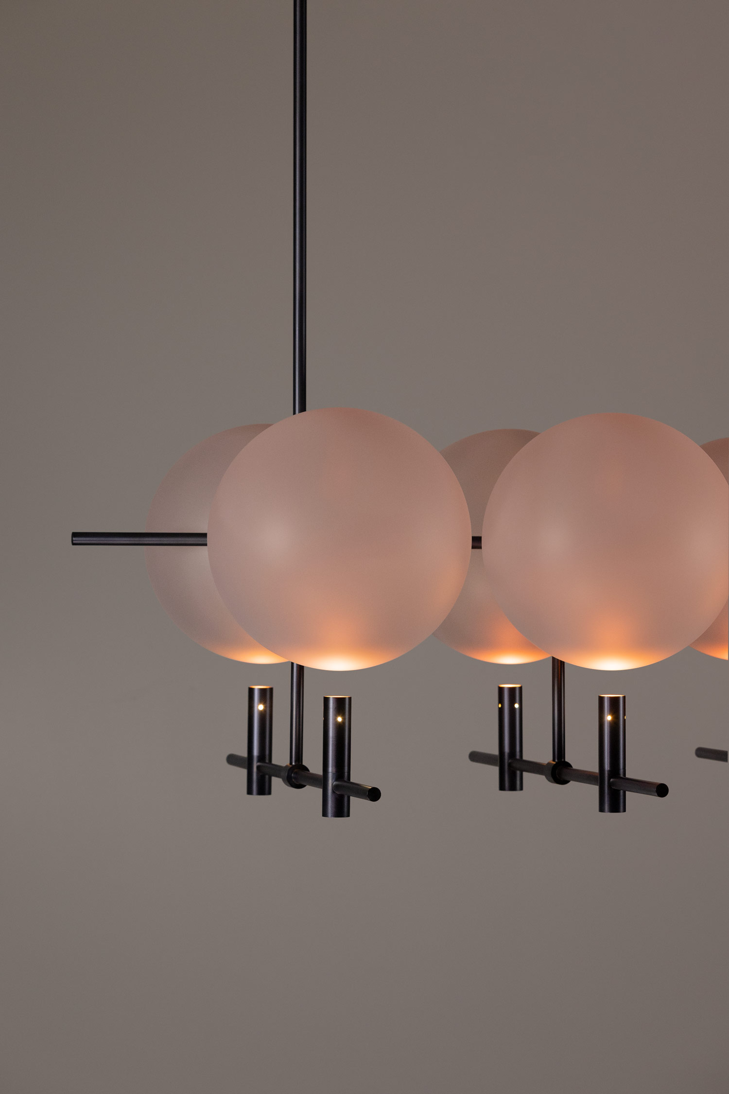 Close-up of Luna II horizontal luminaire showing sandblasted glass spheres and soft light diffusion by Jiri Krejcirik