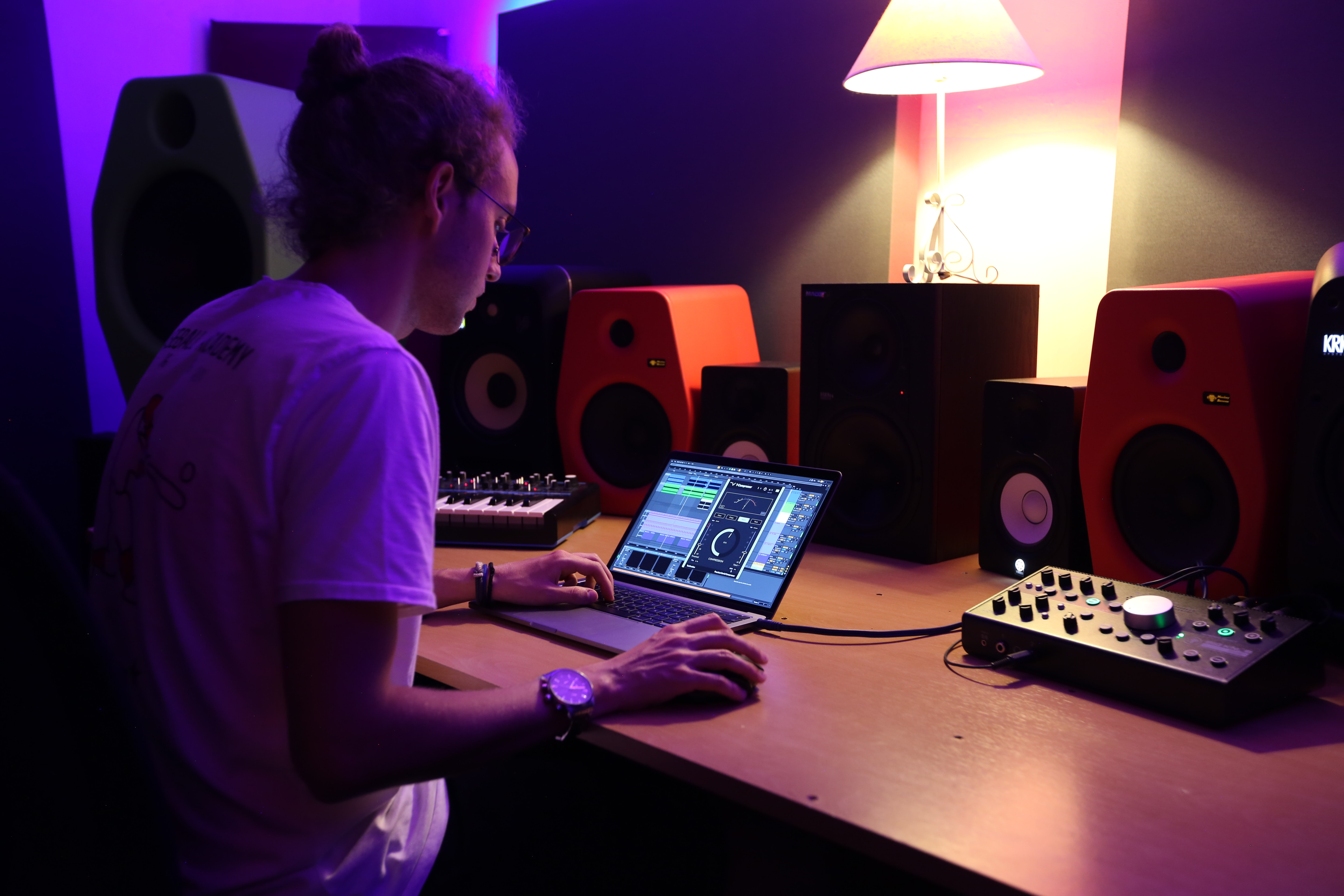 A music producer working on music with a control surface controller