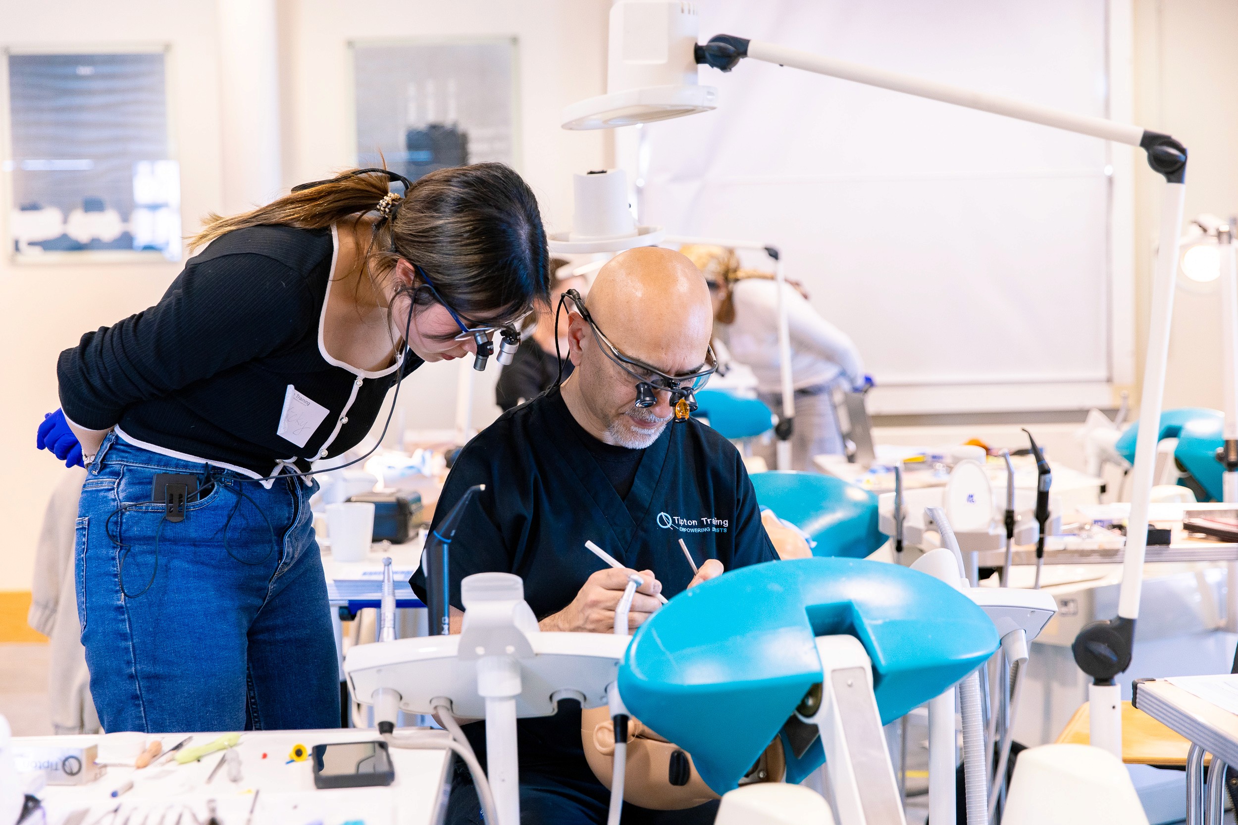 dentists on a dental training course discussing different aesthetic dentistry techniques.