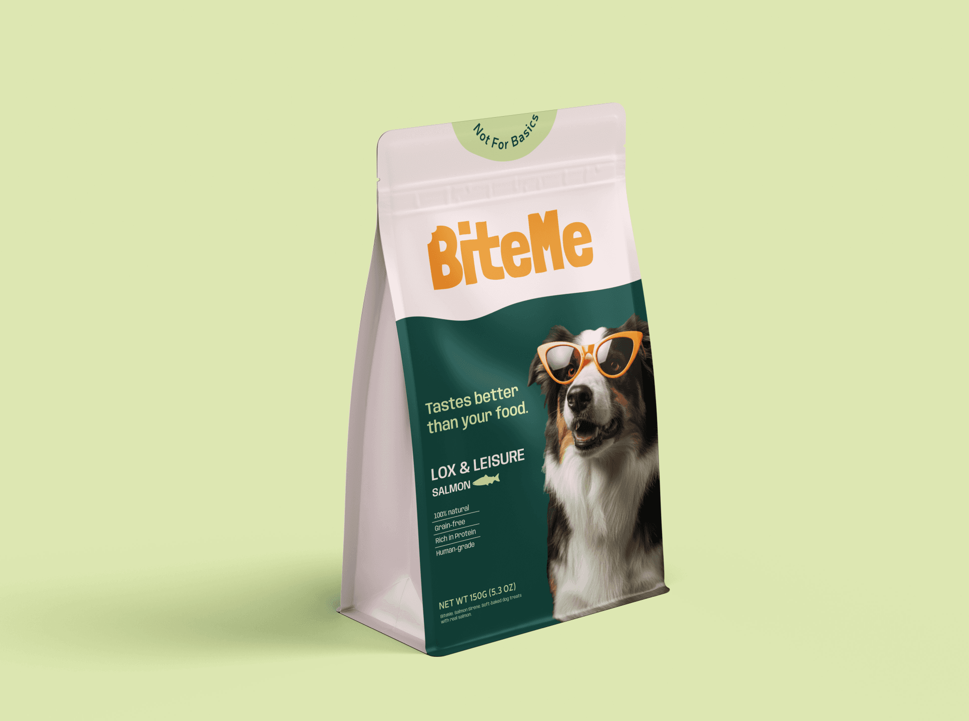 A green and white bag labeled "Bite Me" features an image of a dog wearing orange sunglasses, advertising salmon-flavored dog food against a light green background.