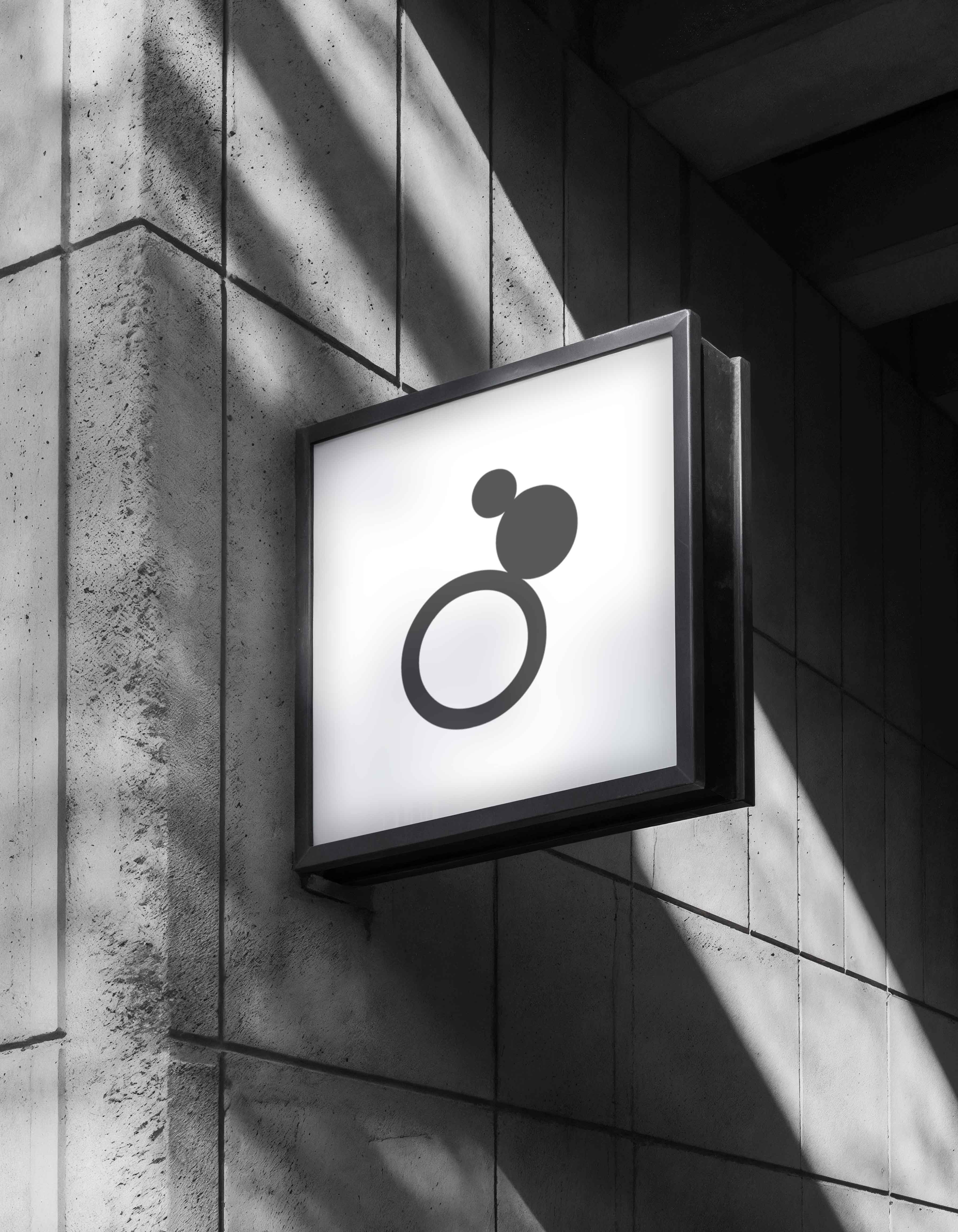 Monochrome product shot: black-capped cosmetic bottle with dynamic water splash on a clean white background.