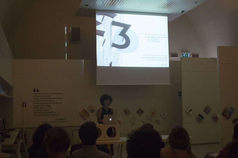woman with pointy glasses giving a presentation