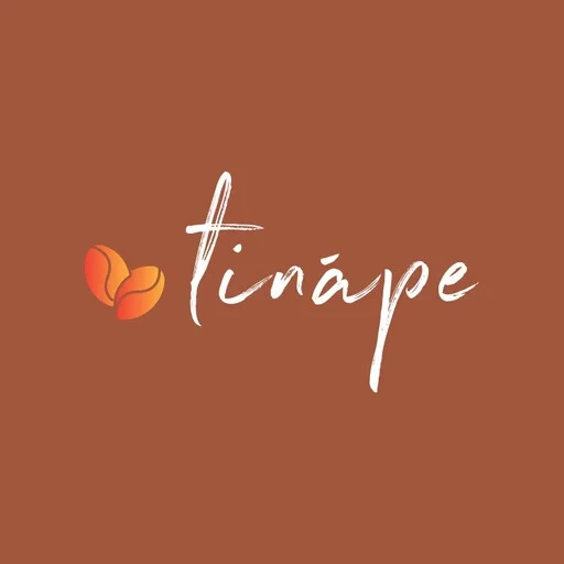 A young woman with long hair smiles while standing against a green backdrop, wearing a casual dark sweater.