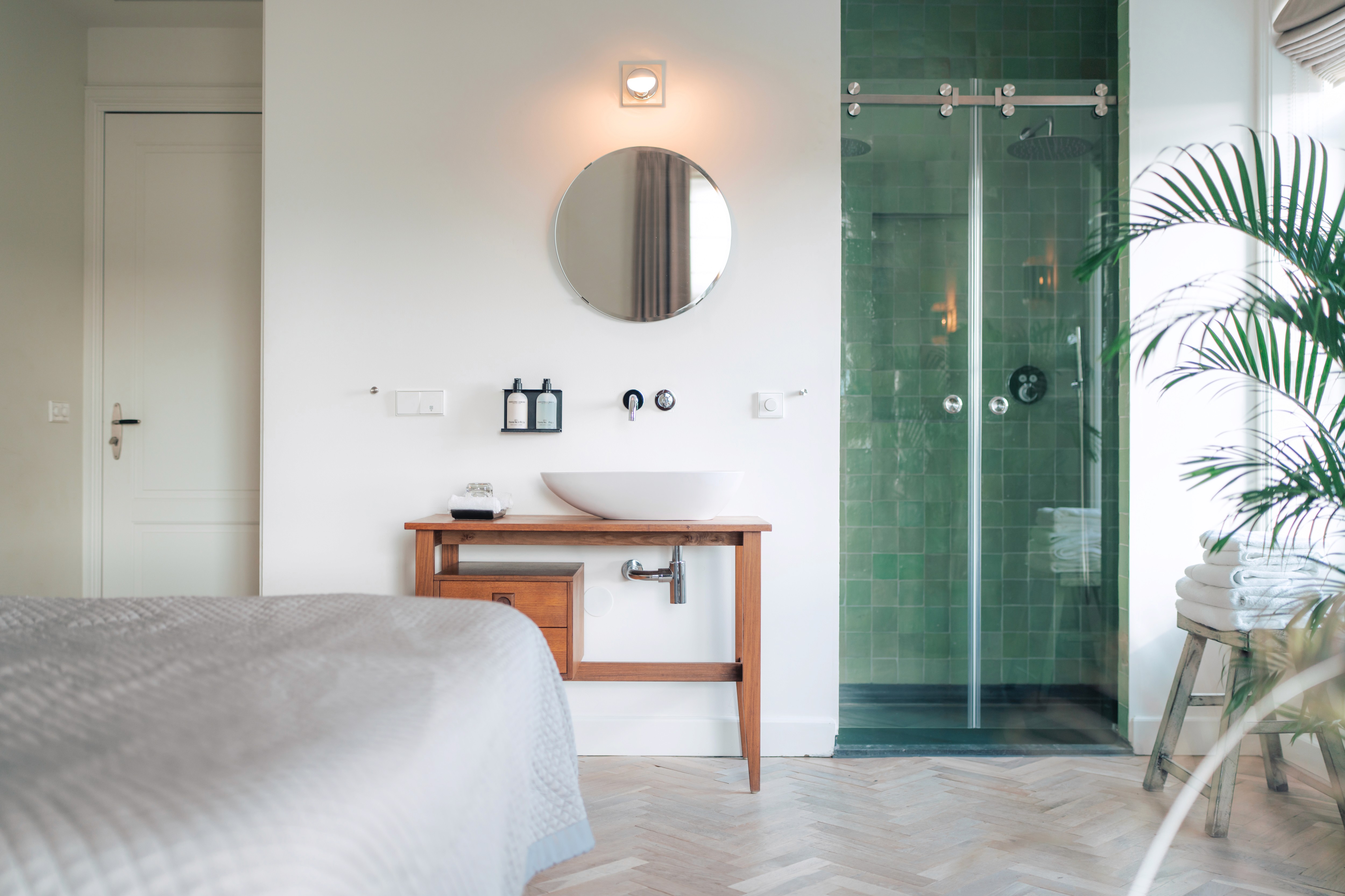 lounge room with large contemporary lamp, cozy sofa and blue toned painting of Venice