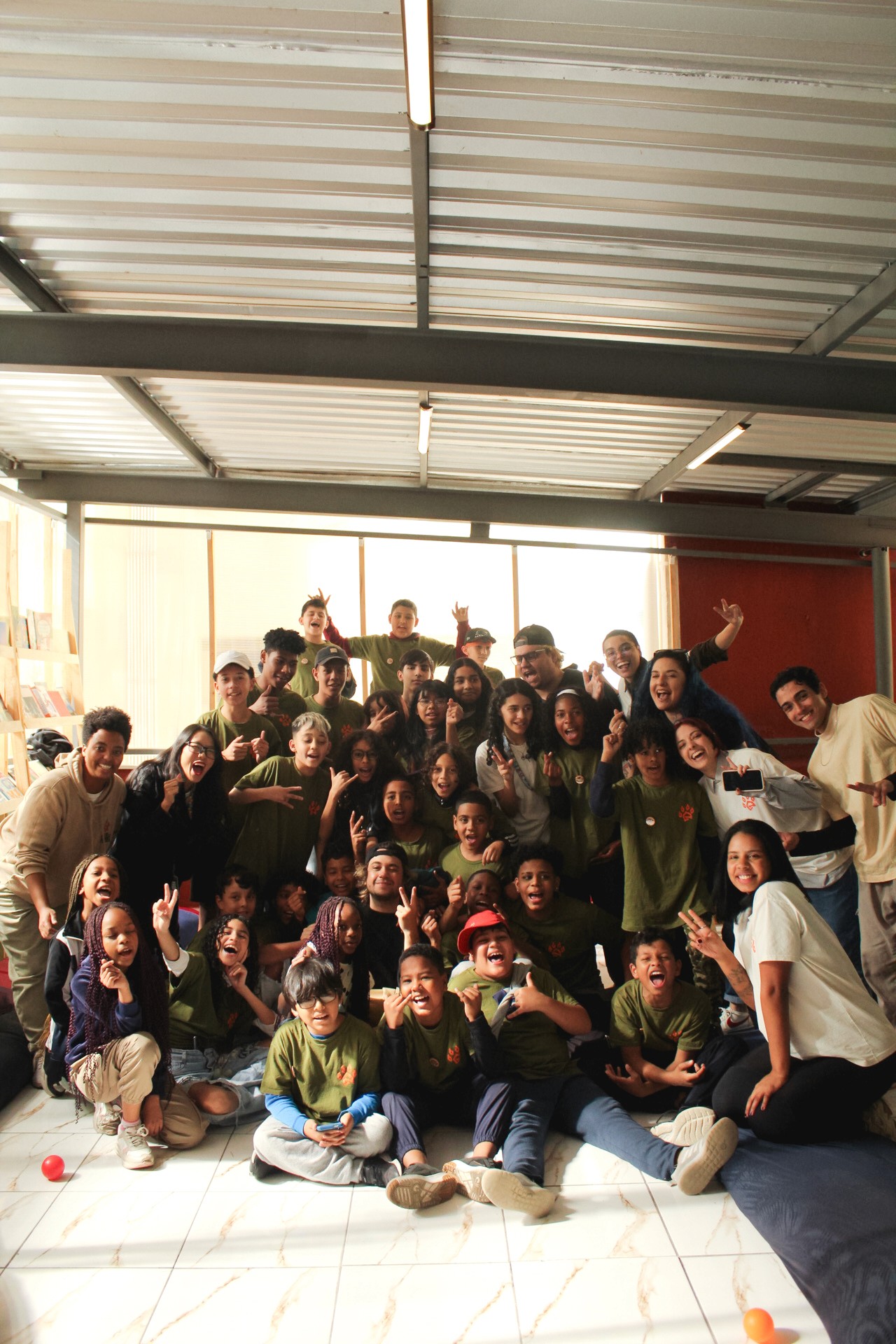 woman in blue tank top standing beside white wall