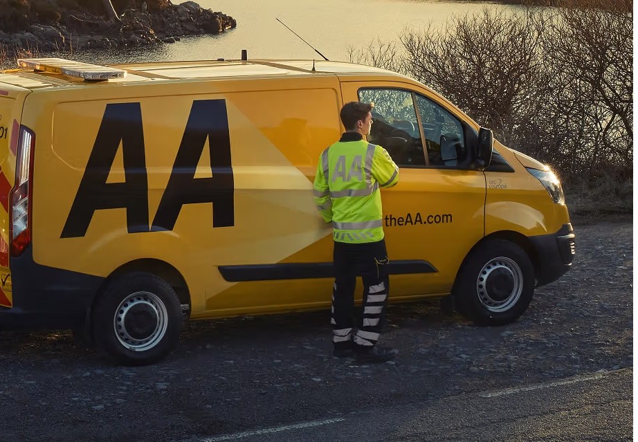 A man is standing by a car