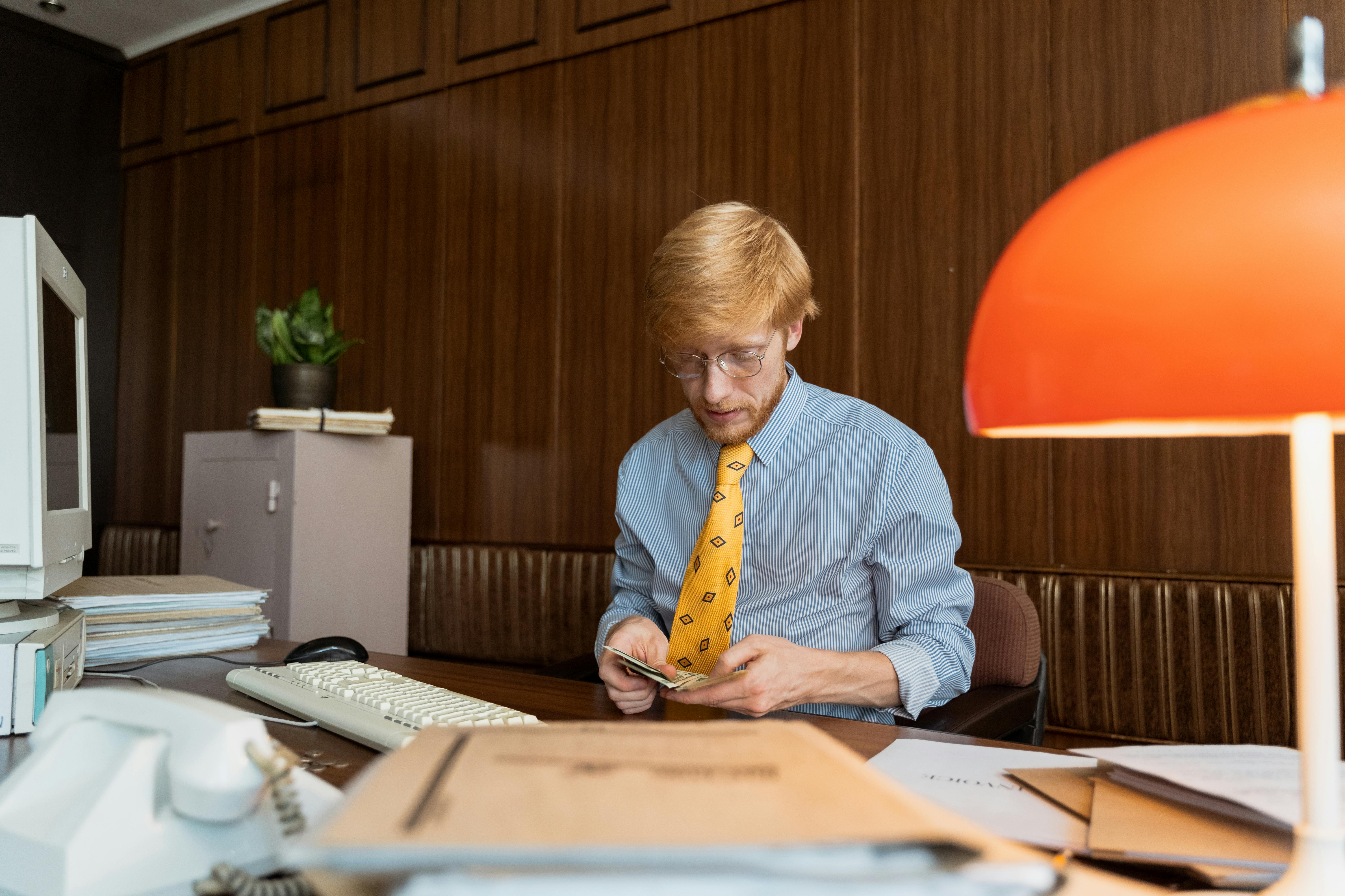 Man counting paper bills to pay broker fee