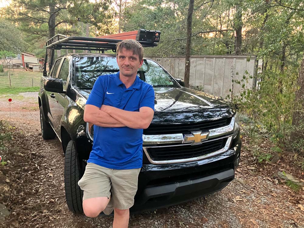 James Tackett stands by his truck that he uses for installas in the greater Birmingham, AL area for surveillance, security, and alarms.