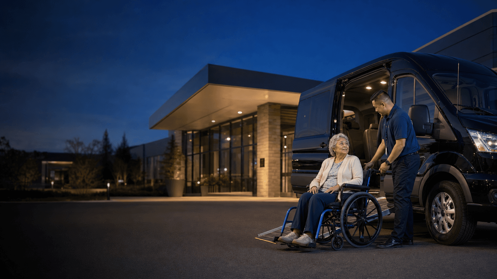 A wheelchair passenger beside an accessible vehicle at dusk