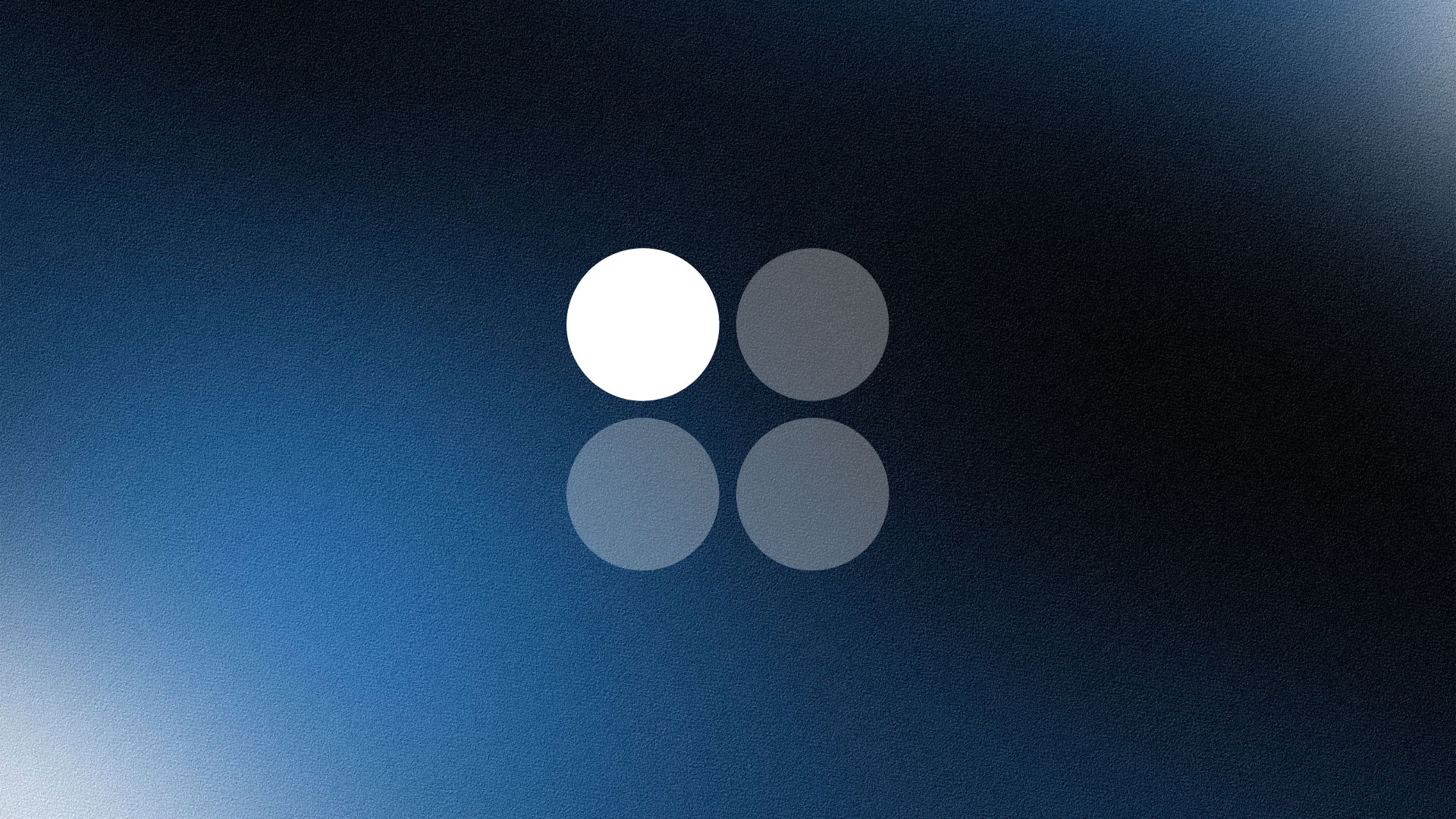 Man wearing a beige cap and dark shirt working on a laptop at a wooden desk with a plant in the background.