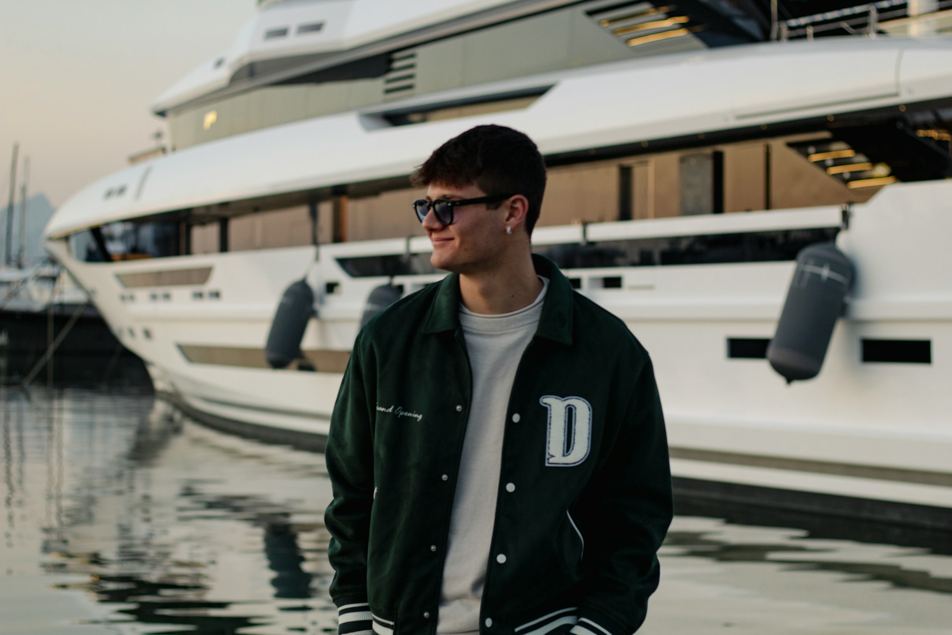 Boy next to yacht