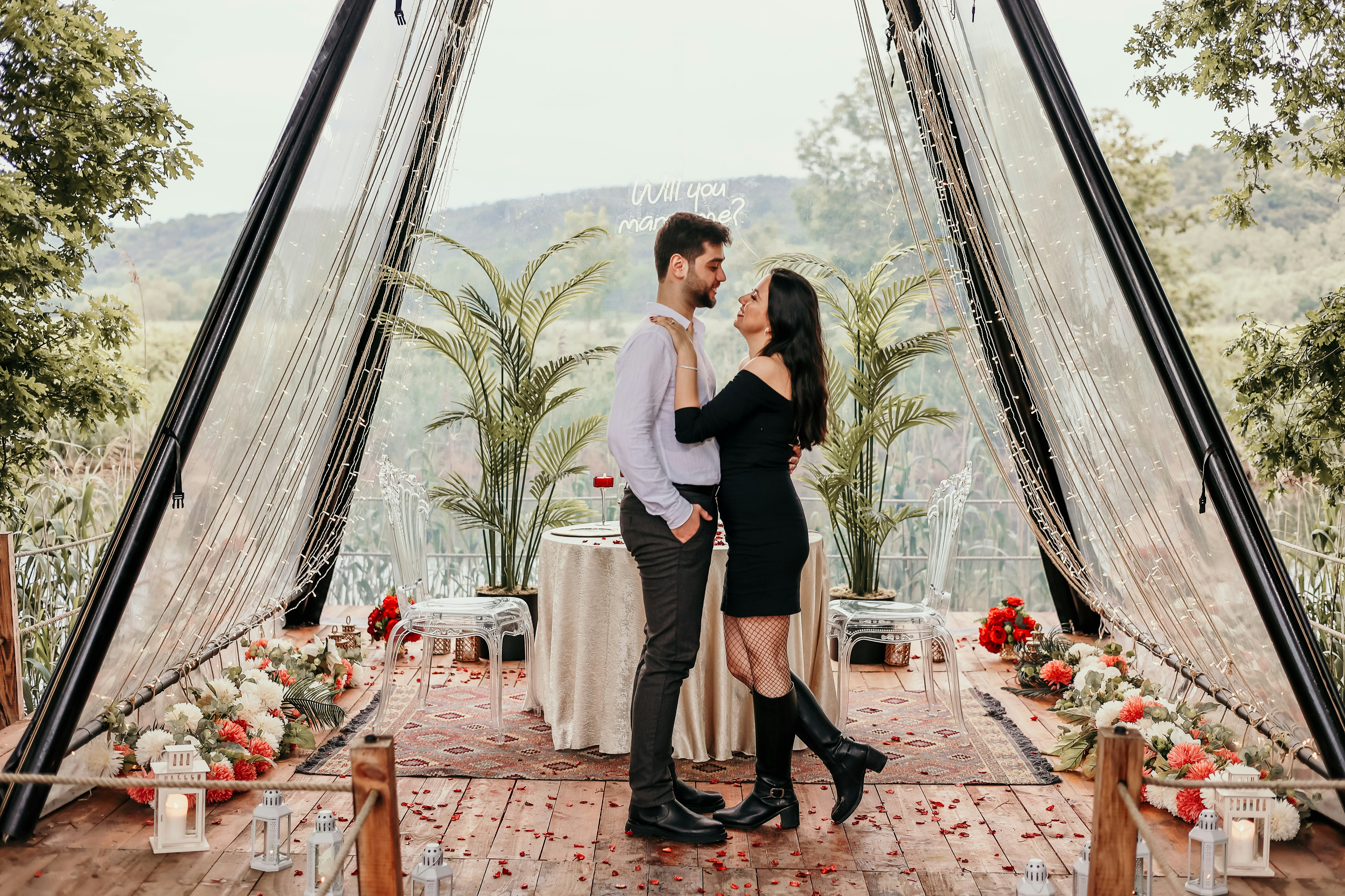 a man and a woman standing in front of a table