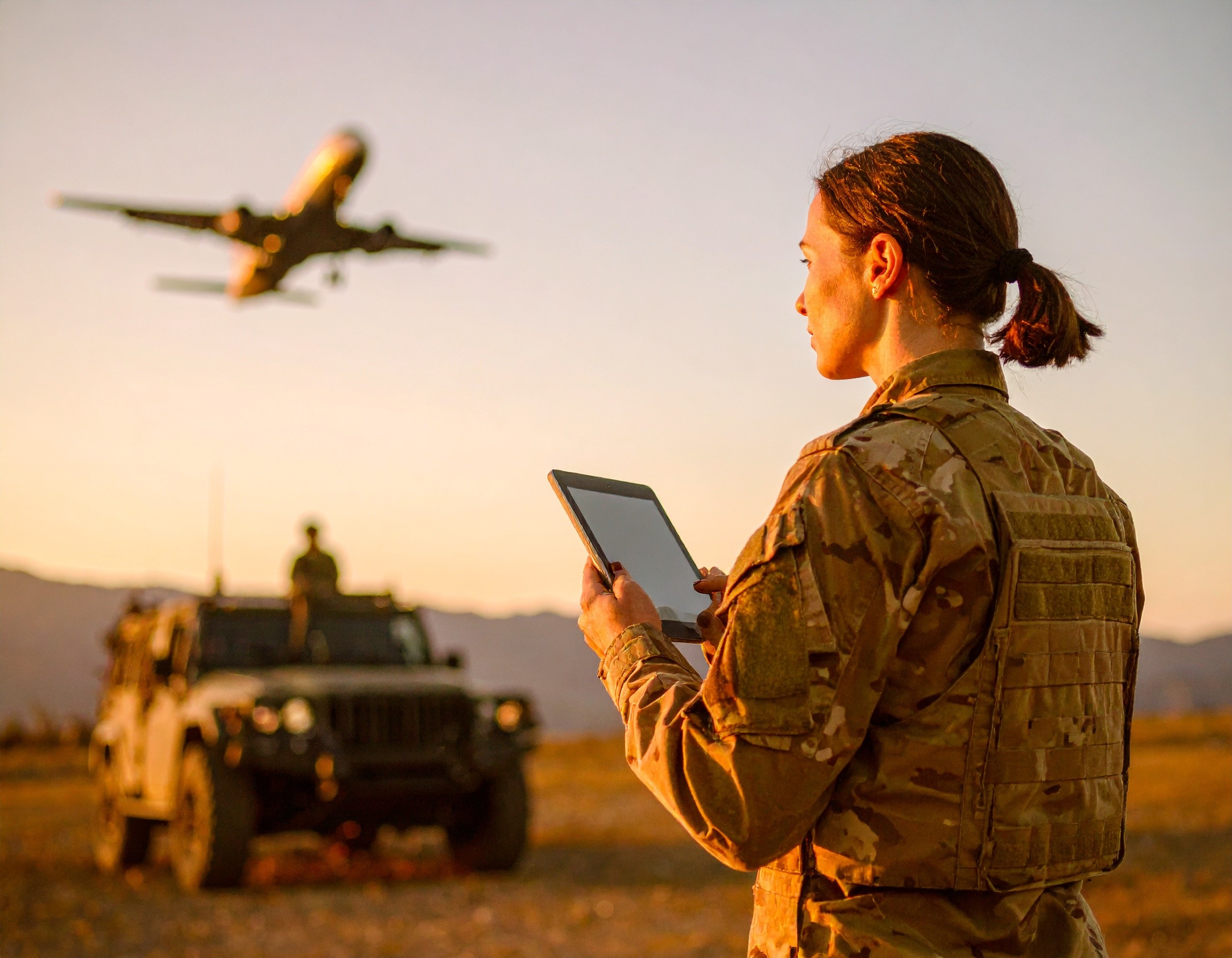 aircraft taking off and spec ops soldier on tablet