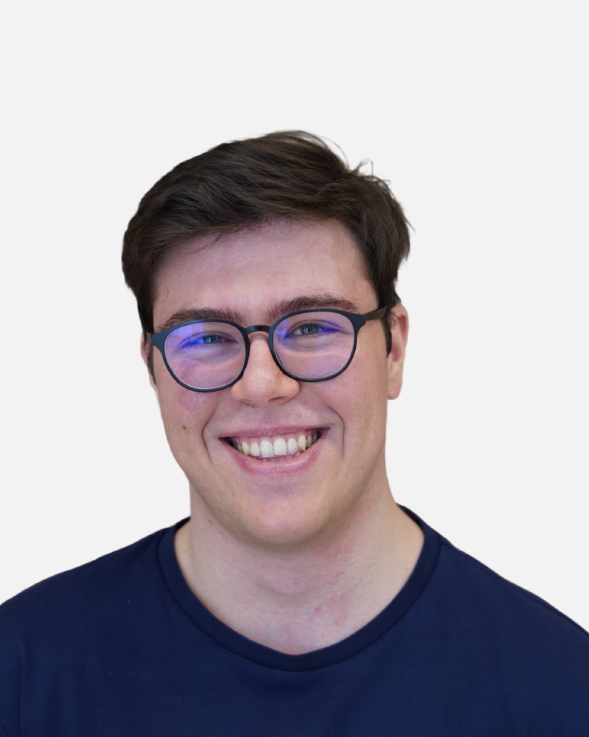 the portrait photo of a young and good-looking man, looking directly to the camera. The mean is wearing glasses and has a dark hair