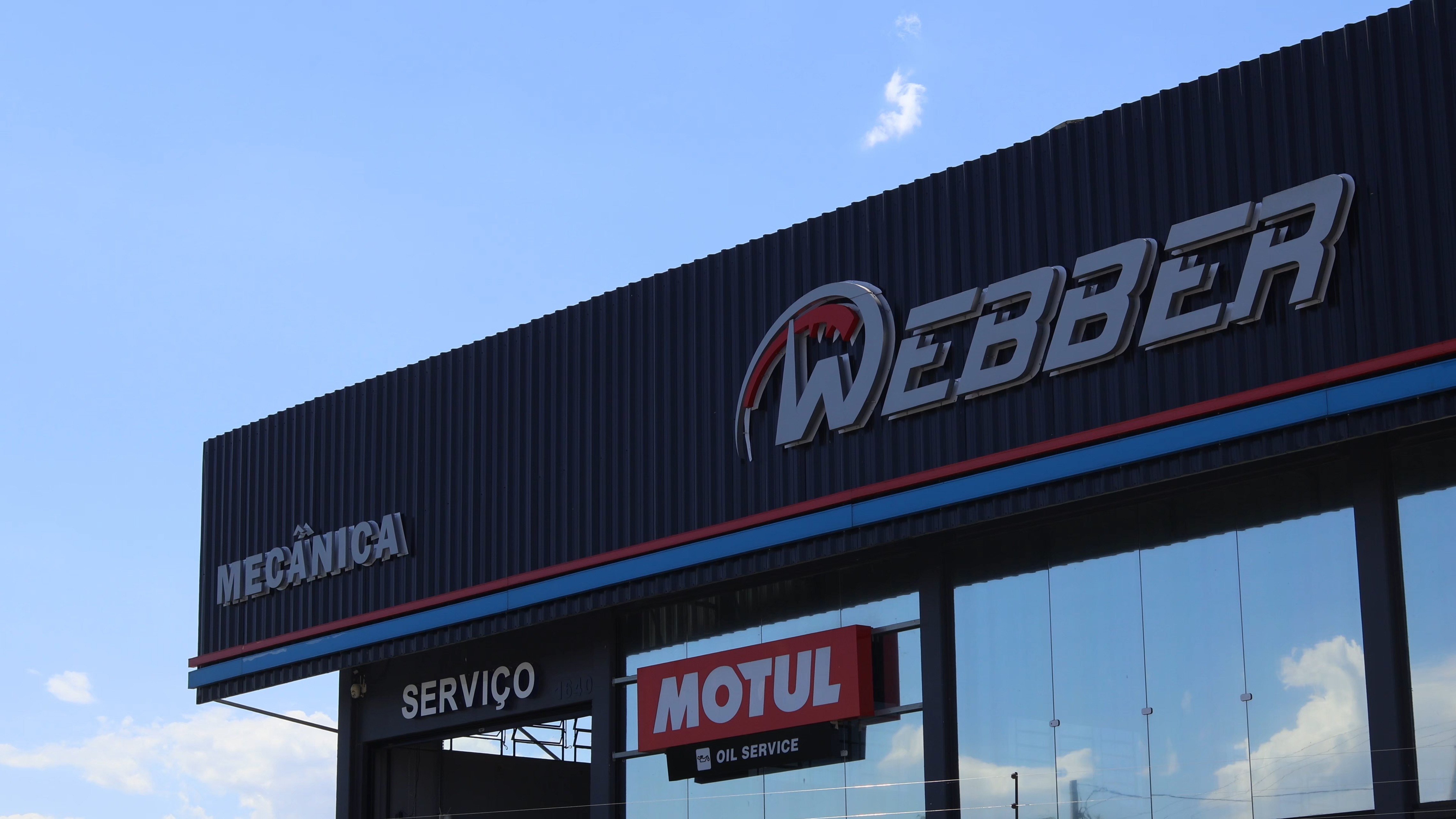 Two cheerful men laughing in the front seats of a sportscar, great for car rental joy promotions.