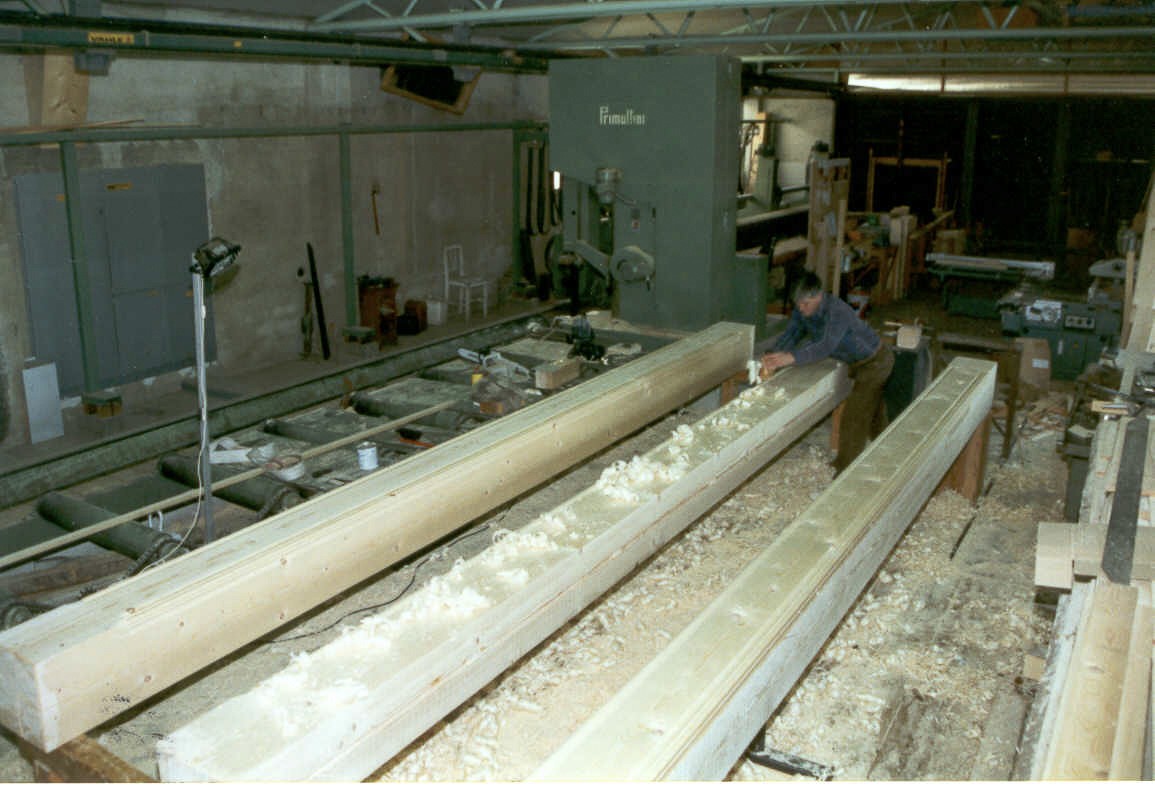 a person cutting a piece of wood with a knife