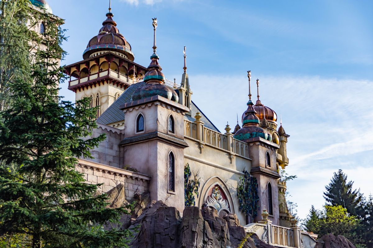 brown and white temple surrounded by green trees during daytime