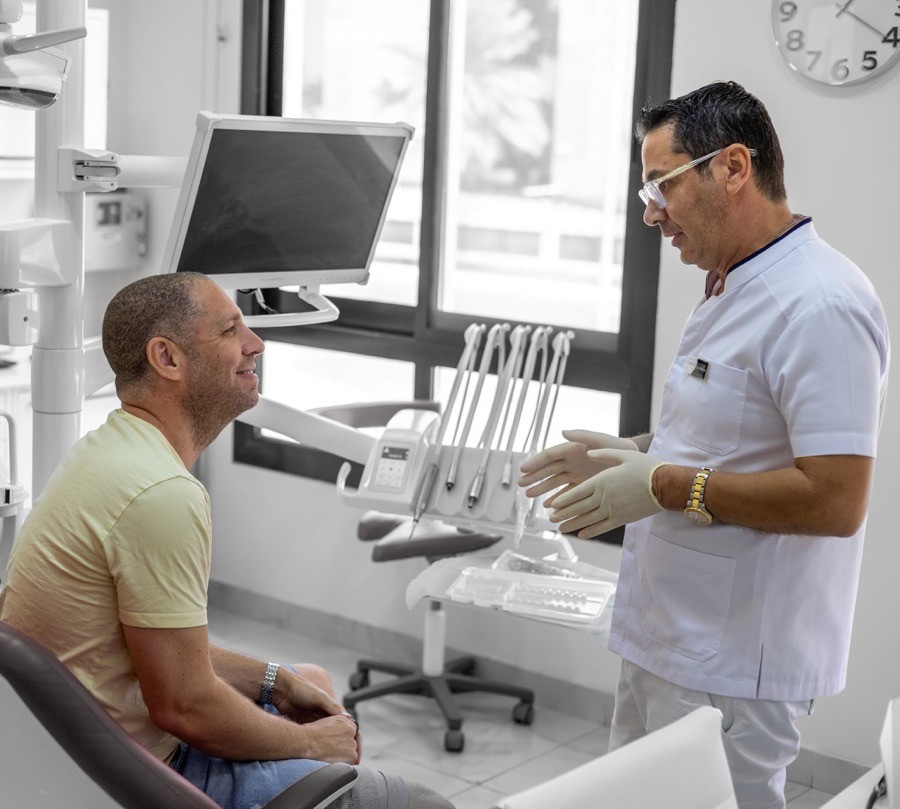 Dentist at Bella Medical Centre discussing personalized dental care plans with a patient.