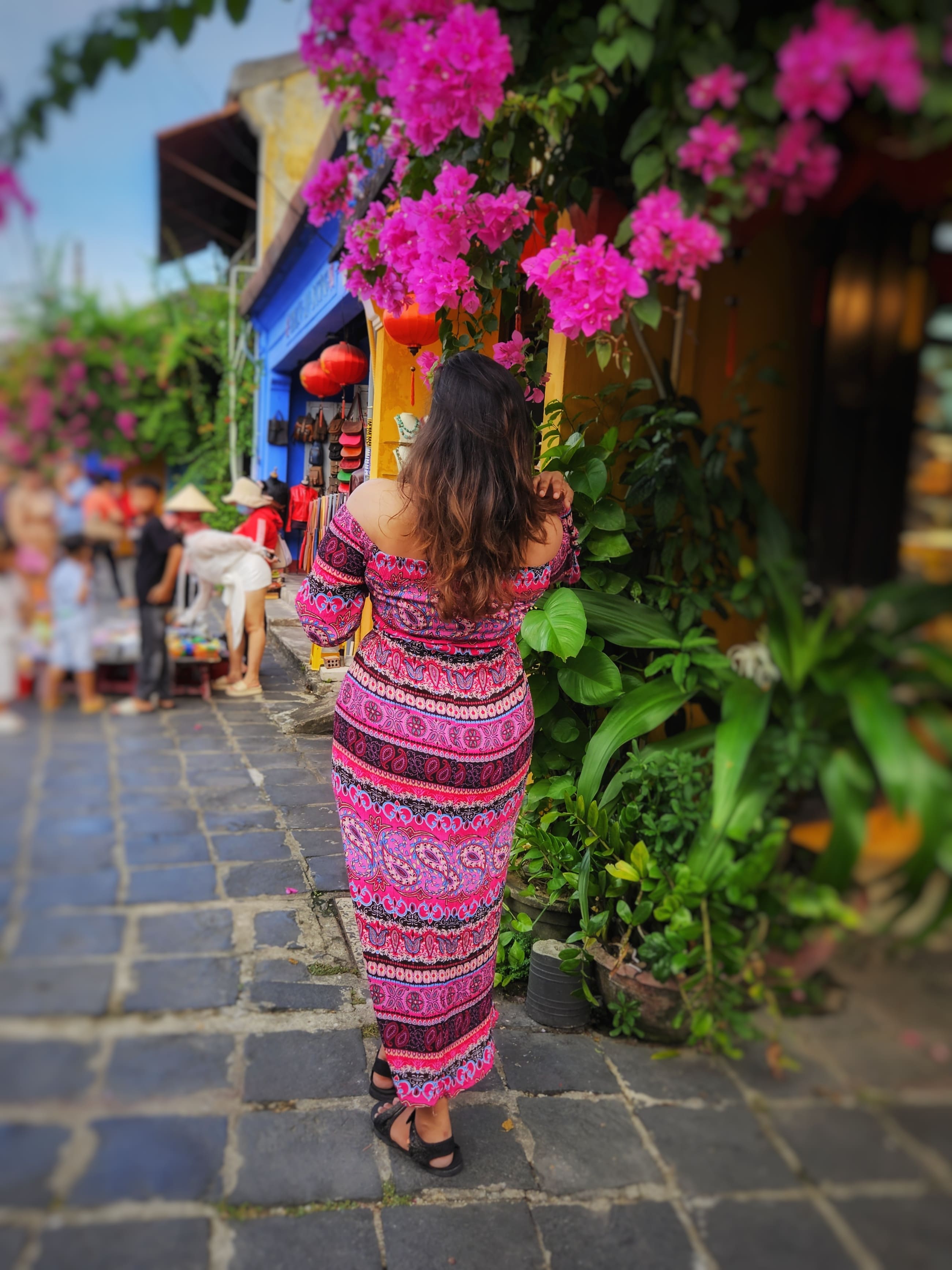 a japanese style building with a japanese roof and trees around it