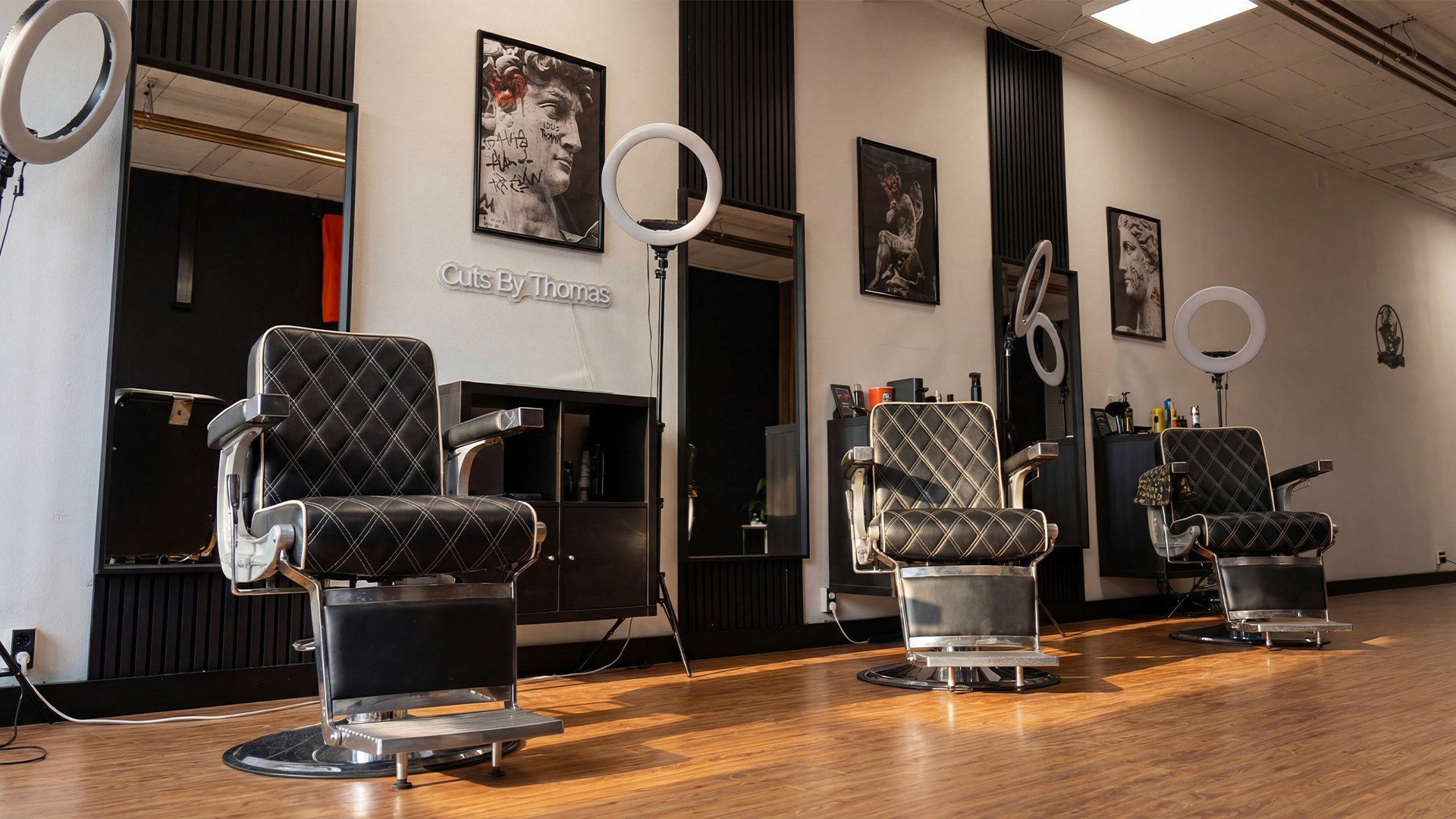 Barber styling a red-bearded man's hair