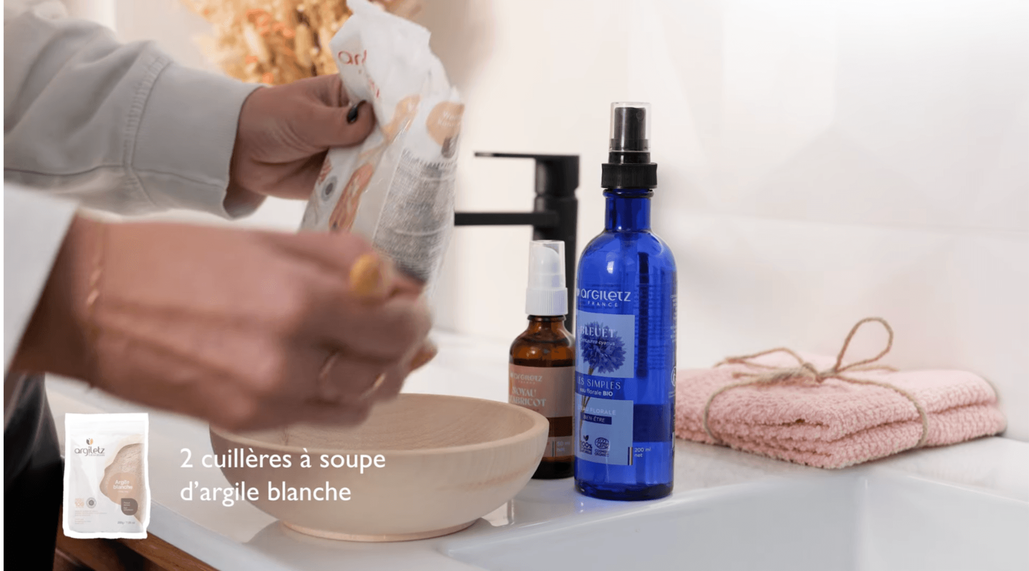 A man in a grey shirt sits in a dim office, gazing seriously at a computer screen. Blinds and office supplies create a focused and professional atmosphere.