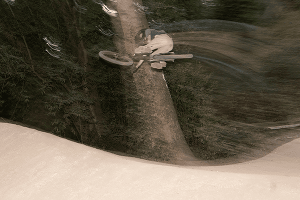 Donny Campion performing crazy jump on mountain bike.