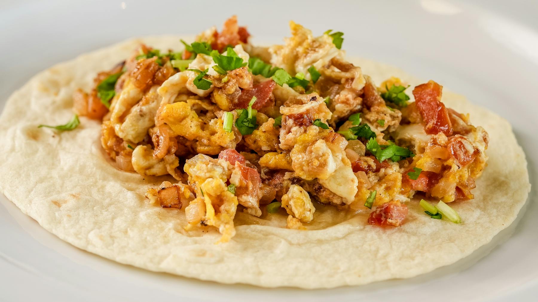 MIXTECO TACO Ripe tomatoes, crisp onions, scrambled eggs, and fresh cilantro, all wrapped in a soft tortilla