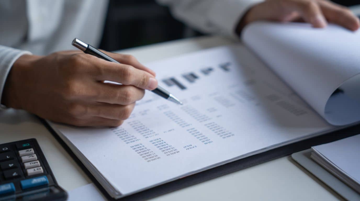 man wearing gray polo shirt beside dry-erase board