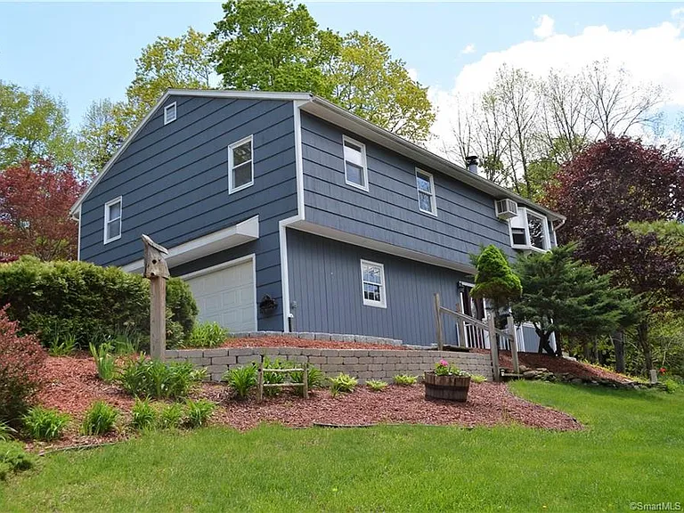 Blue home with green grass