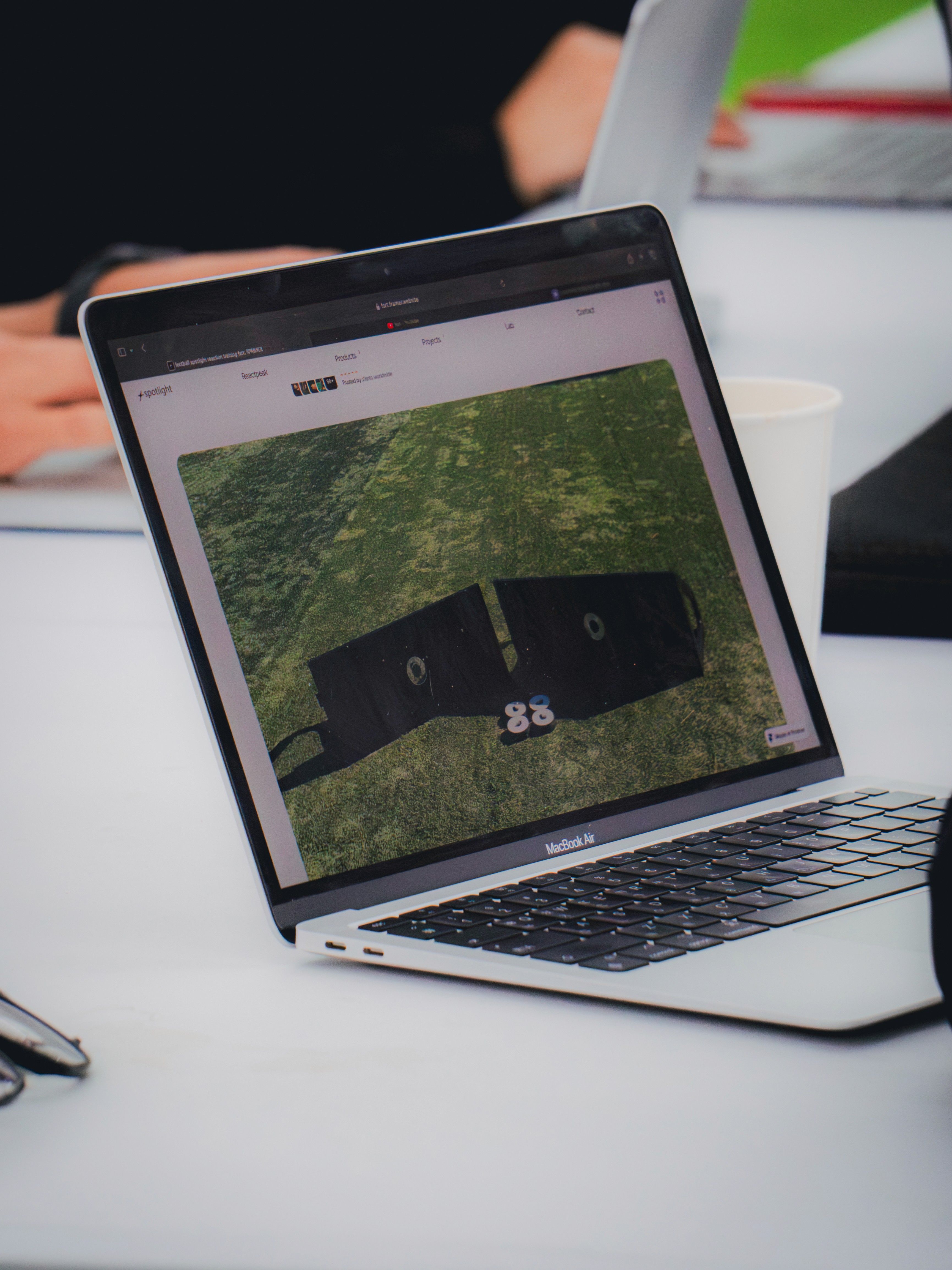 A group of men sitting next to each other holding soccer balls
