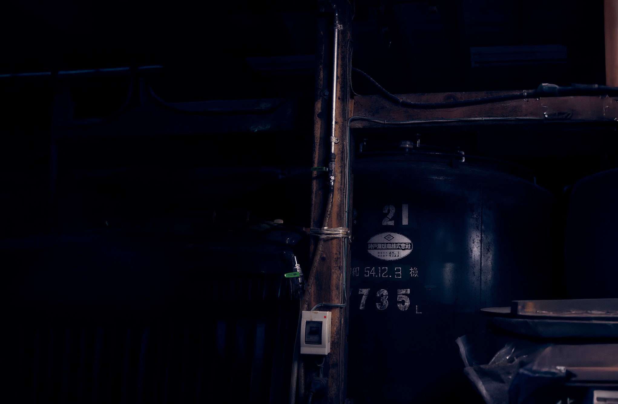 Dark interior of the local Hachijojojima distillery where Zainin shochu is produced.