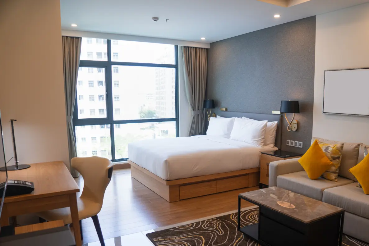 white bed linen with throw pillows