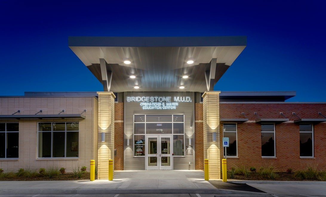 Twilight exterior entry canopy of Bridgestone MUD Operations Center, by Martinez Architects.