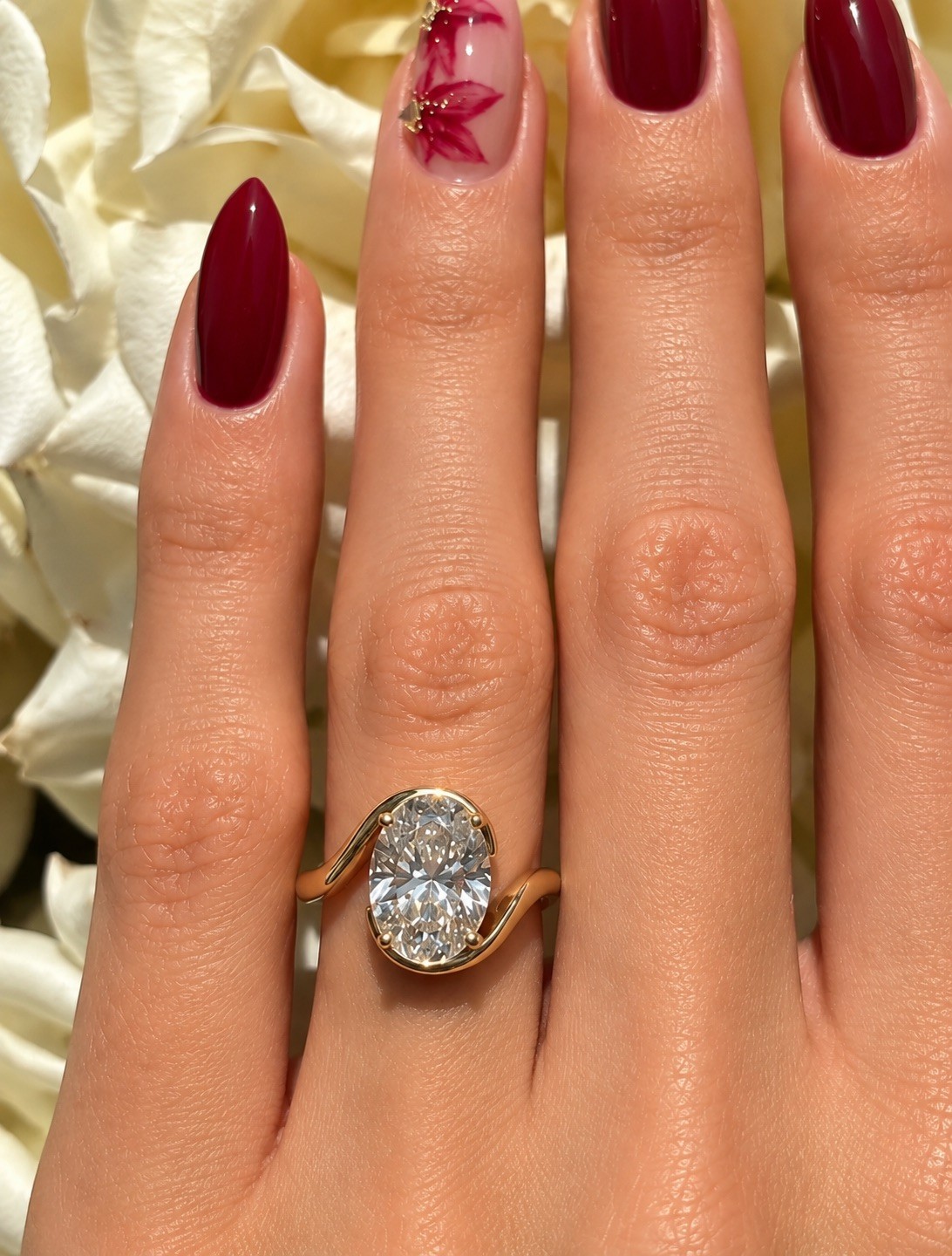 Finished oval diamond ring worn on a hand