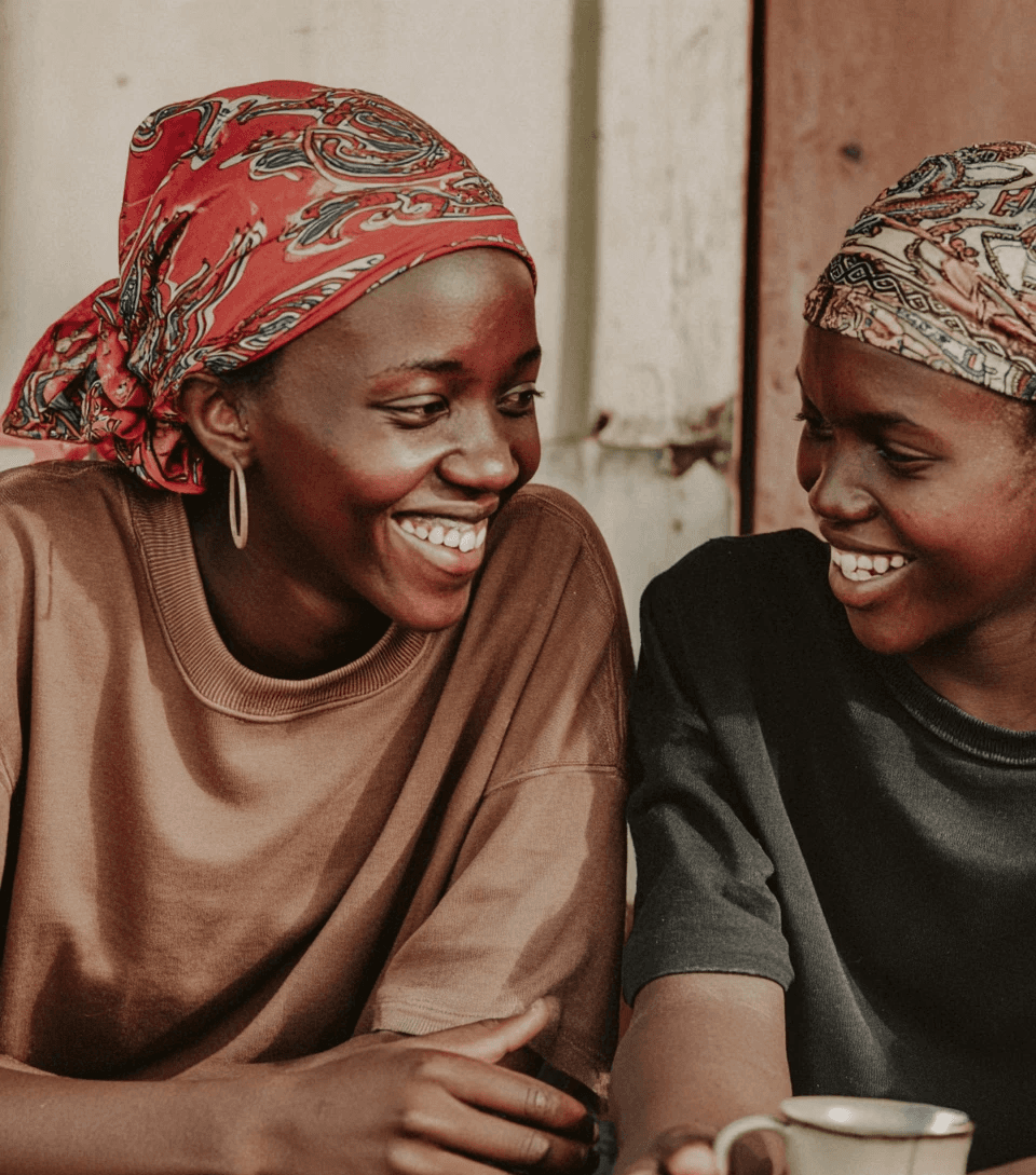 Person climbing a colorful outdoor bouldering wall.
