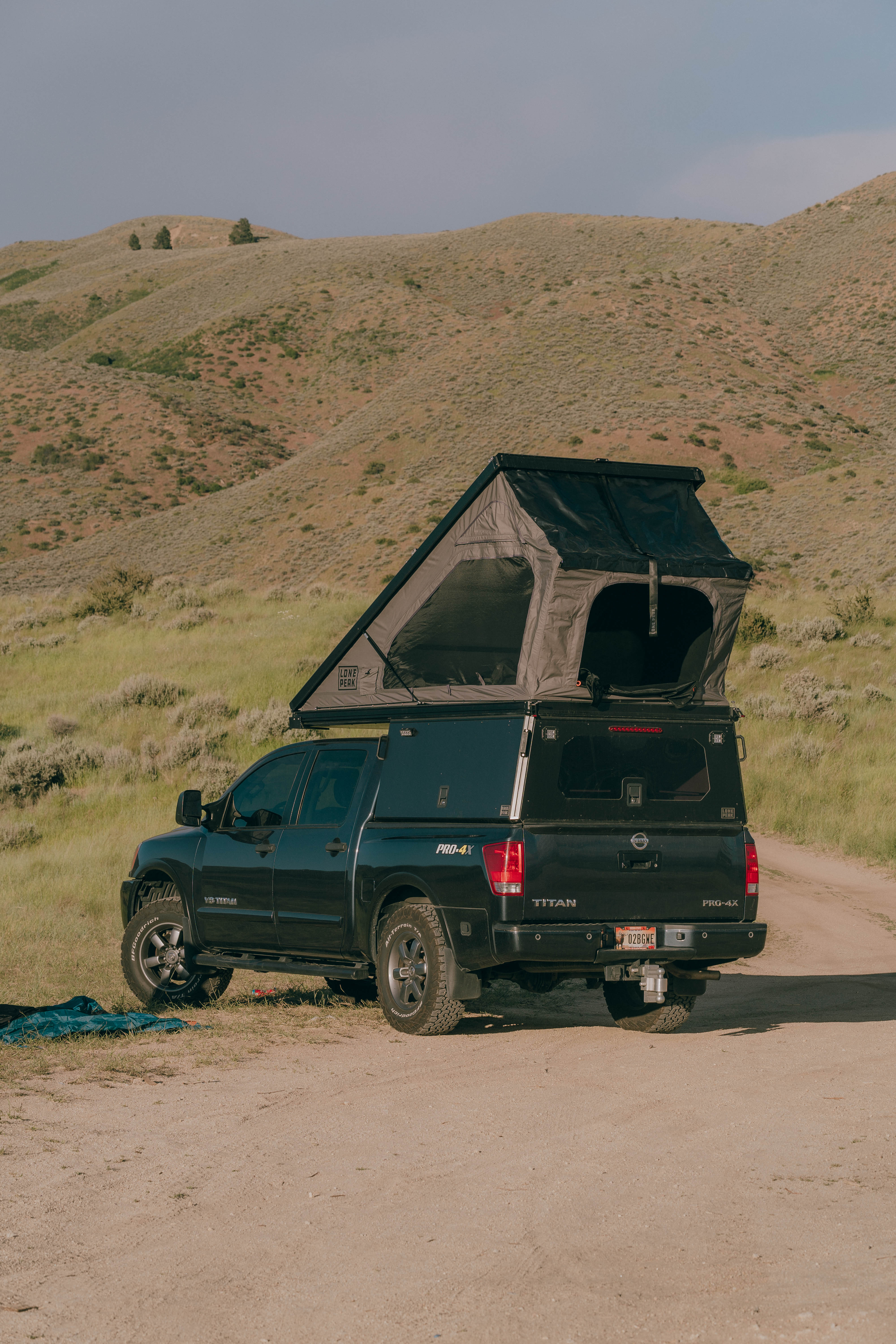 Black and white photo of two people looking at a computer screen with papers on wall