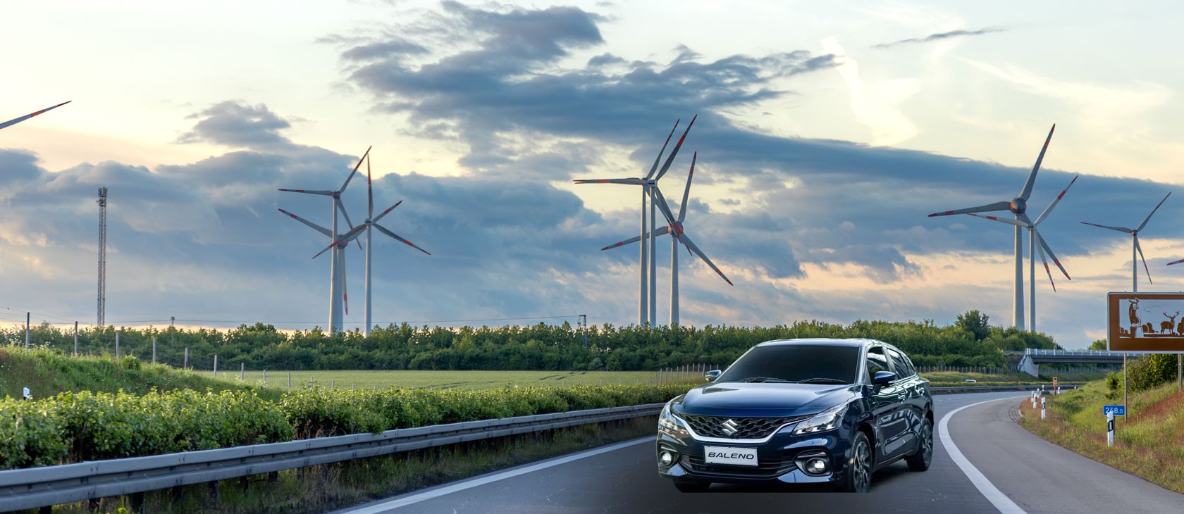 woman in blue tank top standing beside white wall