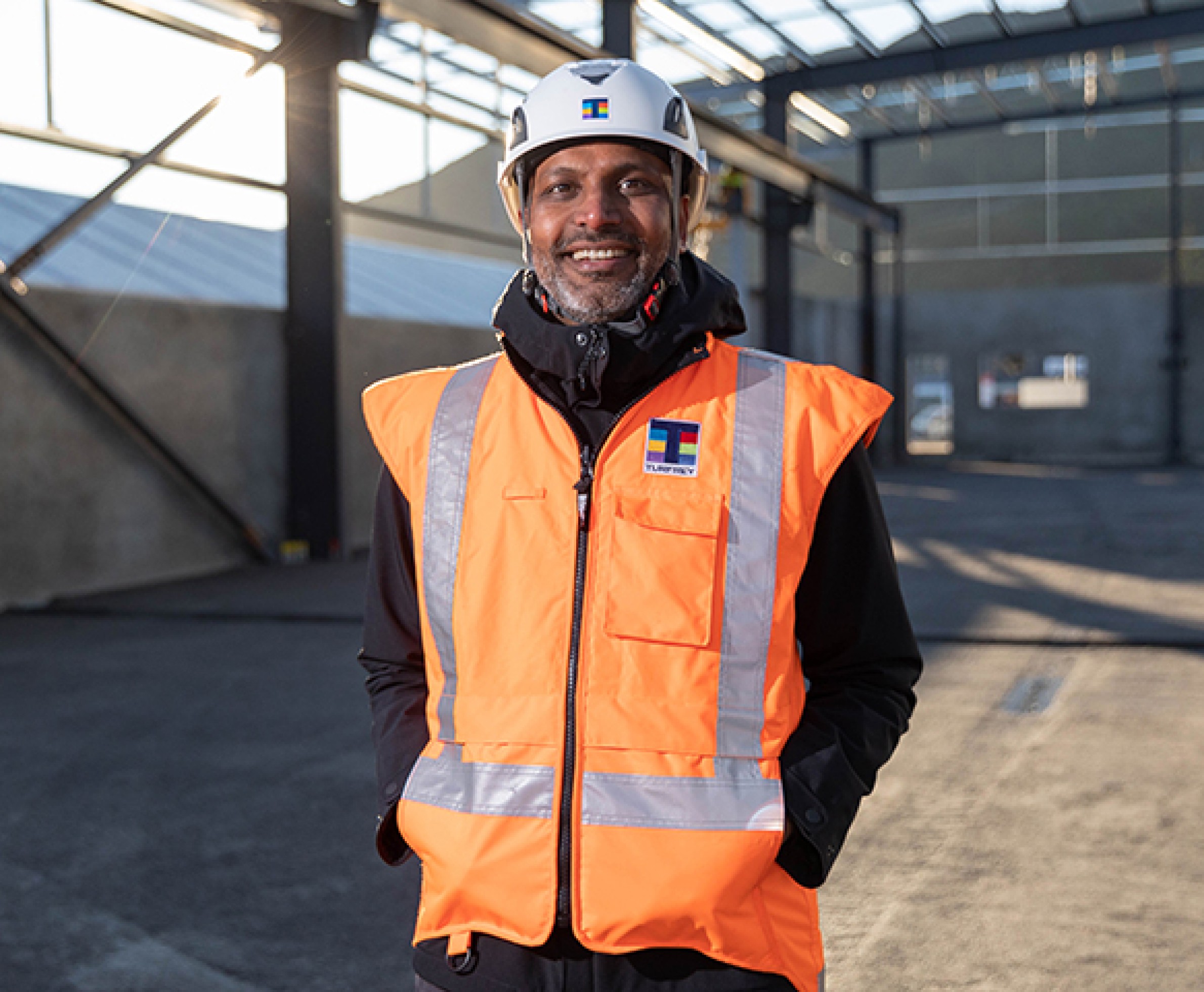 A image of one of the Turfrey team on site, smiling to the camera