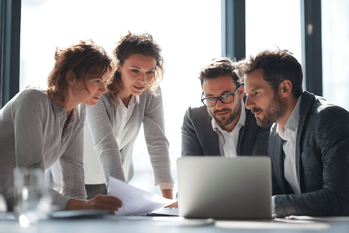 woman in blue tank top standing beside white wall