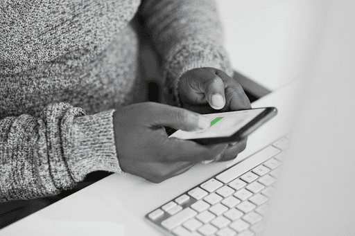 Person verifying identity or confirming transaction on a smartphone — representing Profiled Nigeria’s digital security and mobile verification services.