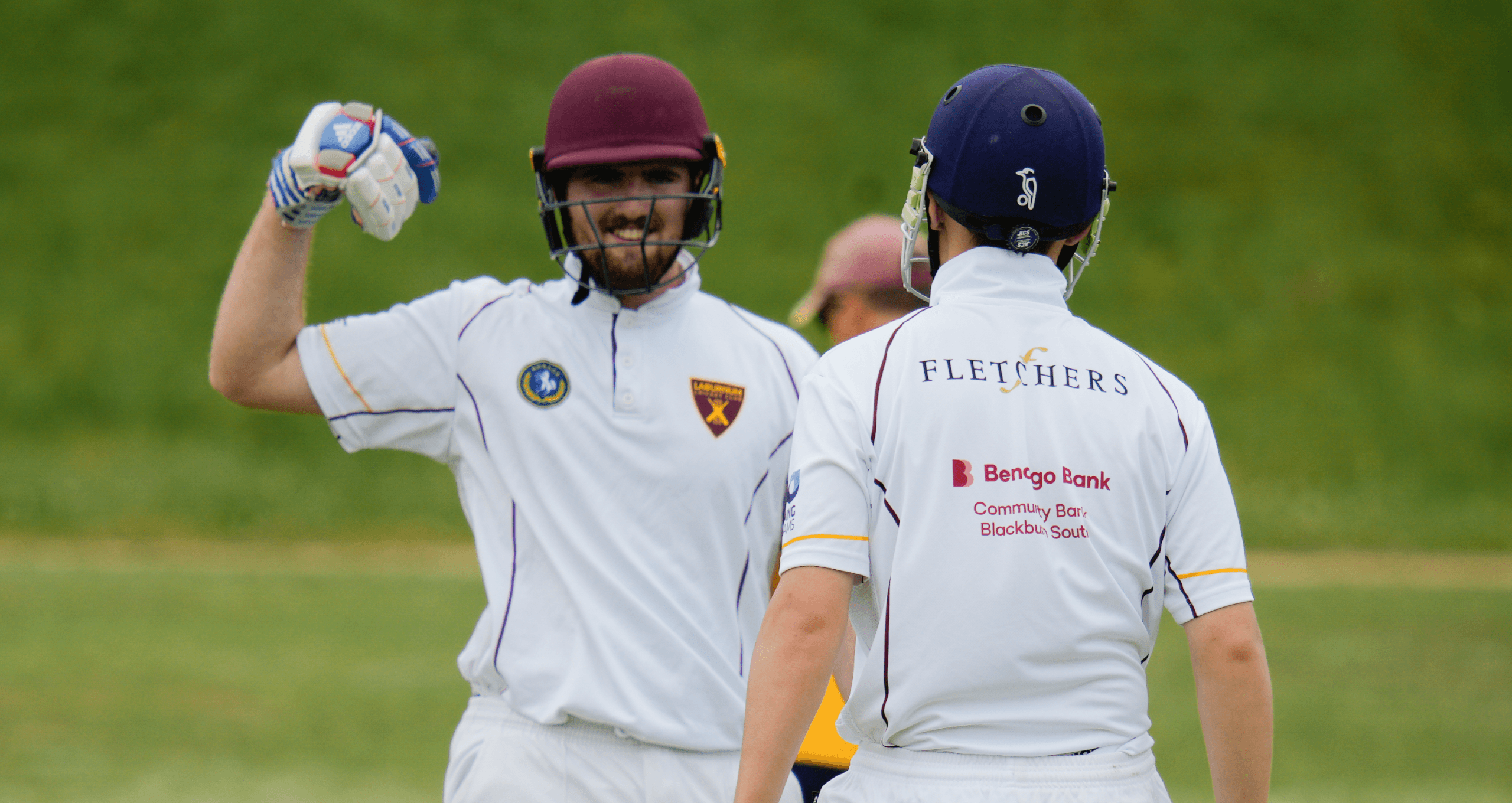 Two cricketers celebrating