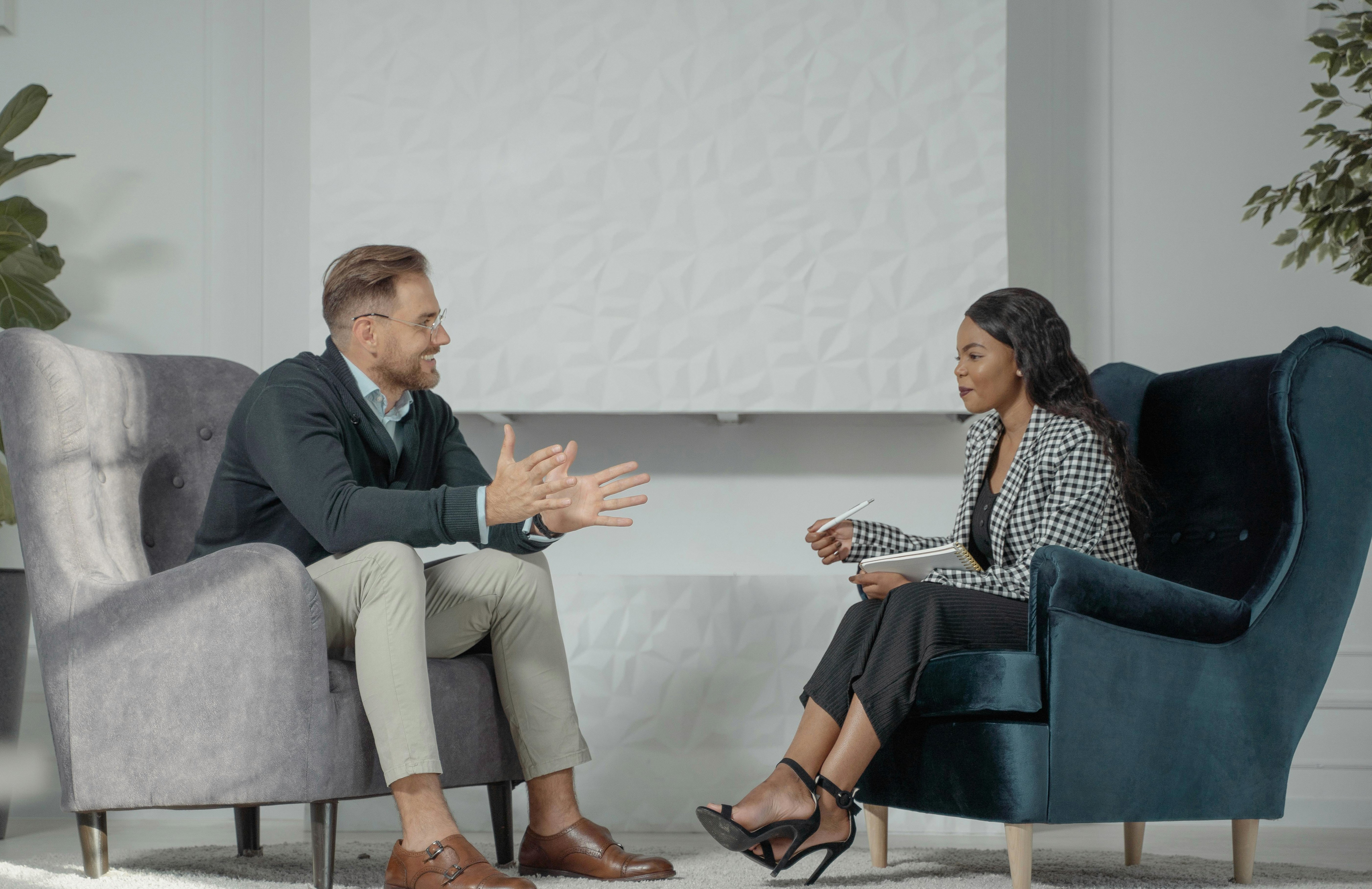 woman holding a phone and man looking at the phone. both are smiling