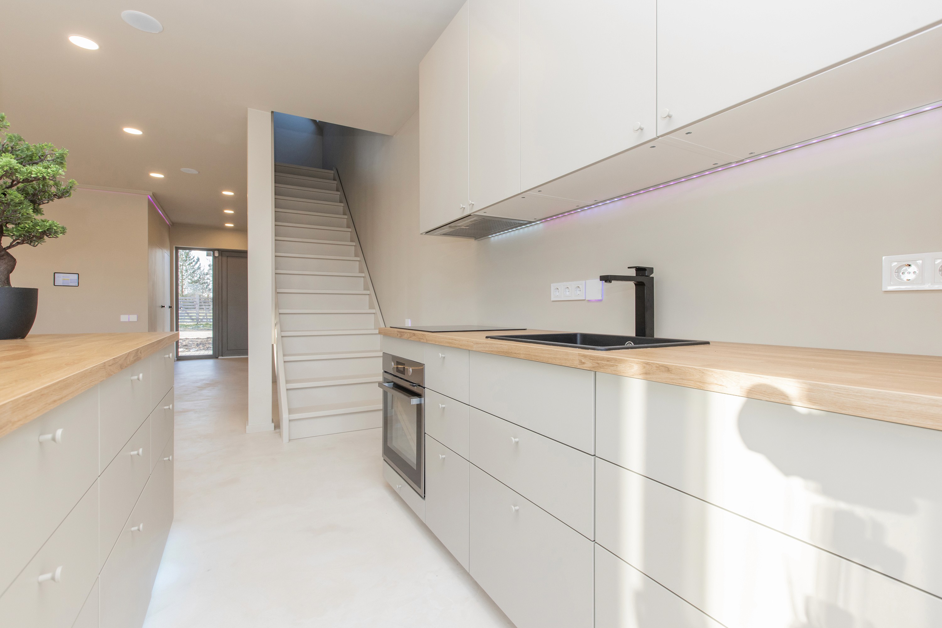 Contemporary kitchen with wooden countertops and clean design inside Grande Build’s tokenized rental housing project.