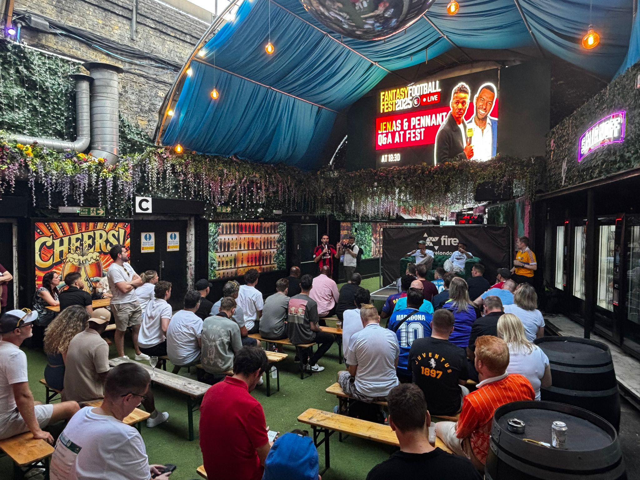 crowd of people sitting on chairs inside room